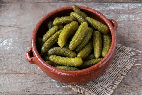 Pickled gherkins on rustic background Stock Photos