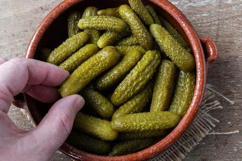 Pickled gherkins on rustic background Stock Photos