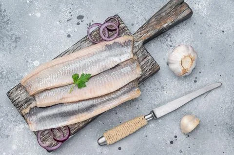 Pickled herring fillets cured in salt and brine with herbs and garlic. Trad.. Stock Photos