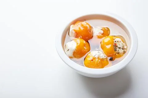 Pickled hot yellow tiny cherry peppers stuffed with soft cream or ricotta che Stock Photos