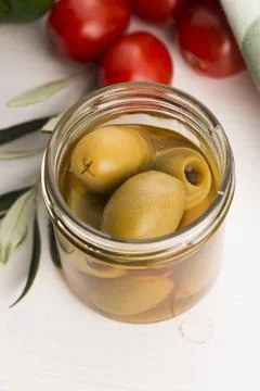 Pickled olives and olive tree branch Stock Photos