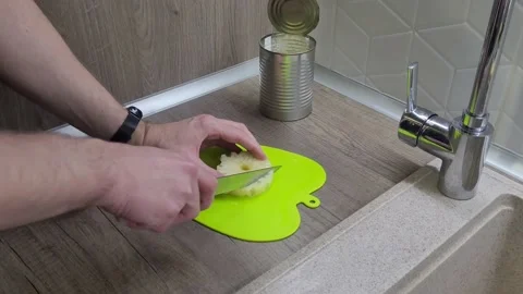 Pickled pineapples in a jar. The chef cuts pineapples with a knife. Stock Footage 231697466