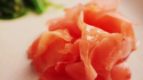 Pickled red ginger for sushi or rolls in a glass bowl. Ginger for Asian cuisine. Stock Footage 314109430