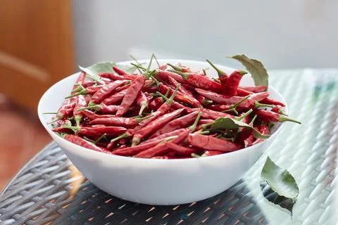 Pickled red hot peppers in a ceramic dish. Stock Photos