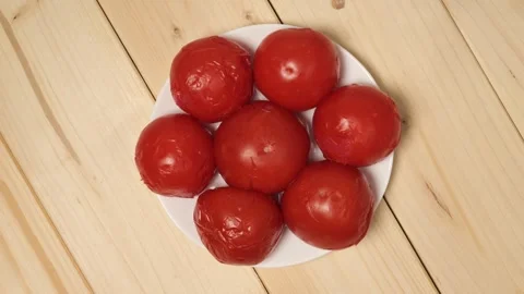 Pickled red tomatoes rotating on plate Stock-Footage 339367070