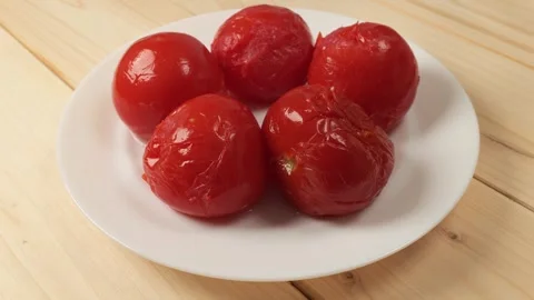 Pickled red tomatoes rotating on plate Stock Footage 342437714