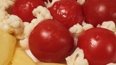 Pickled tomatoes and cauliflower rotating closeup Stock Footage 343435701