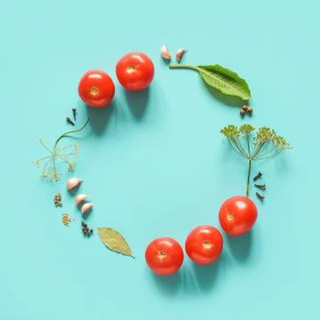 Pickled tomatoes. Circle frame made ingredients for marinated tomatoes on blu Stock Photos