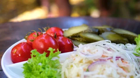Pickled tomatoes, cucumbers and cabbage on a plate Set of chopped fermented Stock Footage 319827138