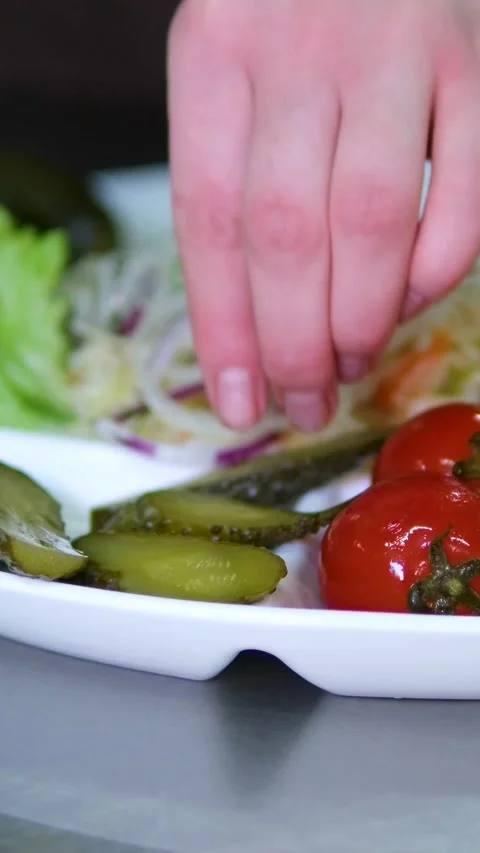 Pickled tomatoes, cucumbers and cabbage on a plate Set of chopped fermented Stock Footage 320724571