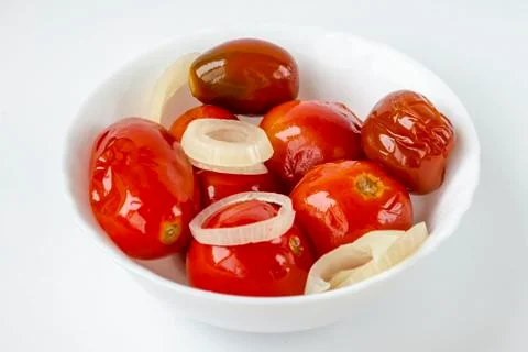 Pickled tomatoes in a white plate. Stock Photos