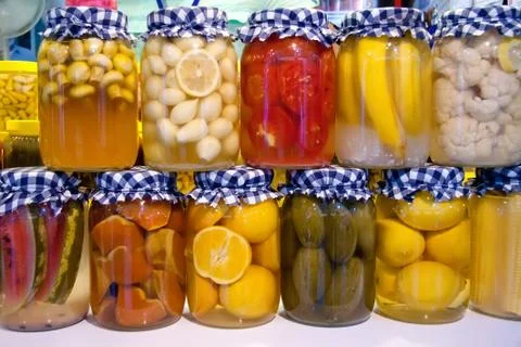 Pickled vegetables and fruit in jars Stock Photos