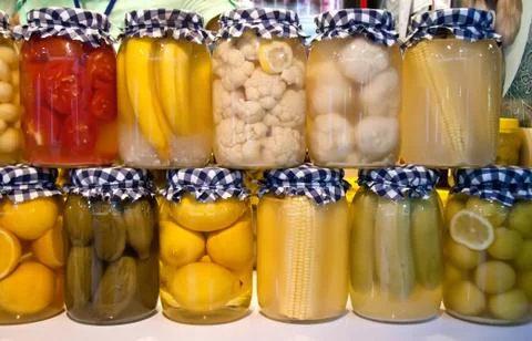 Pickled vegetables and fruit in jars Stock Photos