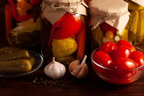 Pickled vegetables, cherry tomatoes, cucumbers and garlic Stock Photos