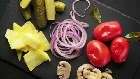 Pickled vegetables set on a slate board, top view, rotation around its axis. Stock Footage 150509196
