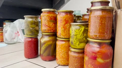 Pickled vegetables, spun for the winter, are under the stairs in the house. Stock Footage 280498960