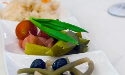 Pickled vegetables on a white plate Stock Photos