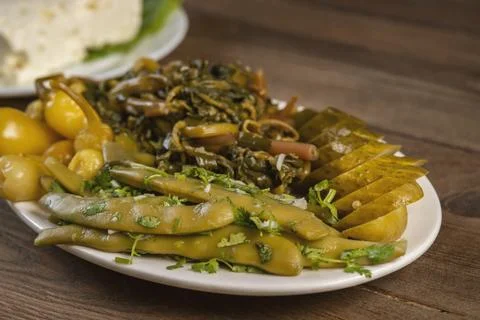 Pickles from different vegetables on a plate, selective focus Stock Photos