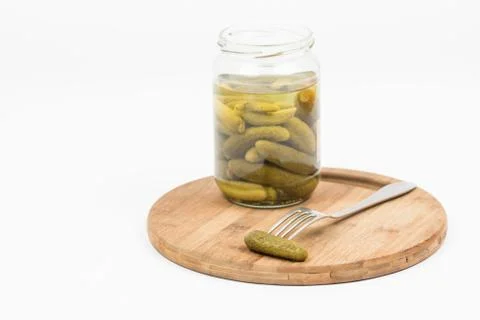 Pickles in the jar and on fork isolated over white background Foto stock