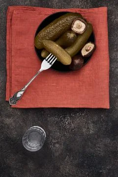 Pickles, mushrooms and stack of vodka, top view, flat lay Stock Photos