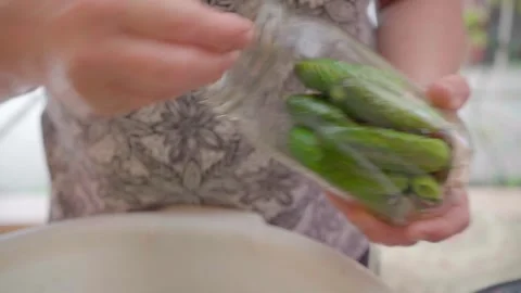 Pickling cucumbers. the process of placing cucumbers in jars. 스톡 동영상 245984452