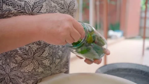 Pickling cucumbers. the process of placing cucumbers in jars. 스톡 동영상 245984466