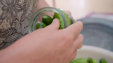 Pickling cucumbers. the process of placing cucumbers in jars. 스톡 동영상 245984475
