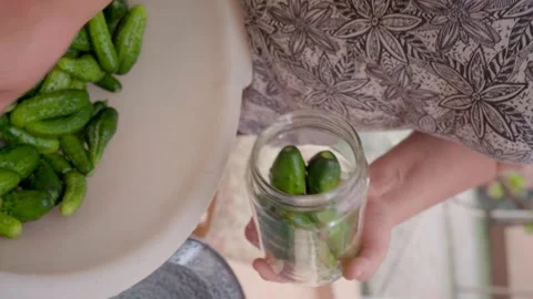 Pickling cucumbers. the process of placing cucumbers in jars. 스톡 동영상 245984499