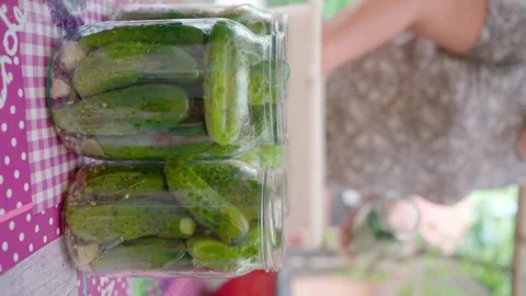 Pickling cucumbers. the process of placing cucumbers in jars. 스톡 동영상 245984535