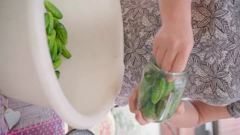 Pickling cucumbers. the process of placing cucumbers in jars. 스톡 동영상 245984550