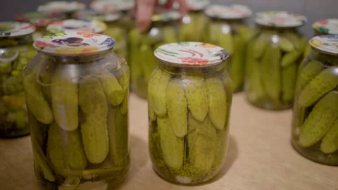 Pickling cucumbers. the process of placing cucumbers in jars. 스톡 동영상 245984574