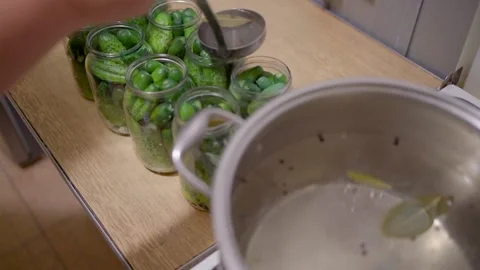 Pickling cucumbers. the process of placing cucumbers in jars. 스톡 동영상 245984597