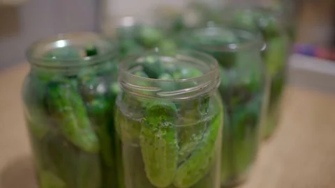 Pickling cucumbers. the process of placing cucumbers in jars. 스톡 동영상 245984607