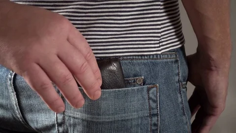 A pickpocket steals the wallet from a mans back pocket. Stock Footage 72156001