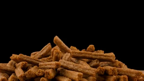 Picks up breadcrumbs on a black background. Beer snack. Close up Stock Footage 135675054