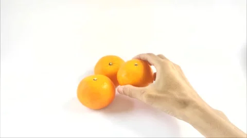 Picks Up An Orange Stock Footage 296723433