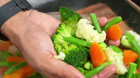 Picks up vegetables from the water and puts it in hand Video stock 286866077