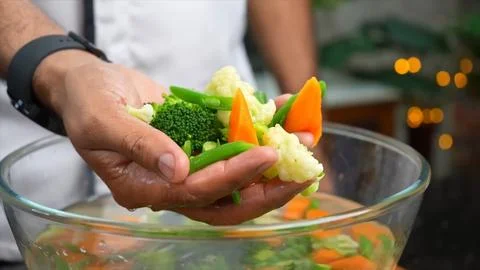 Picks up vegetables from the water and puts it in hand Stock Photos