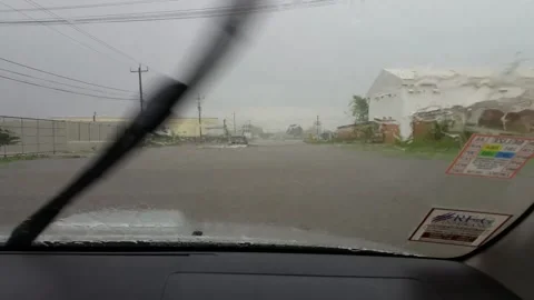 A Pickup truck driving in flooded streets through Belize City Stock Footage