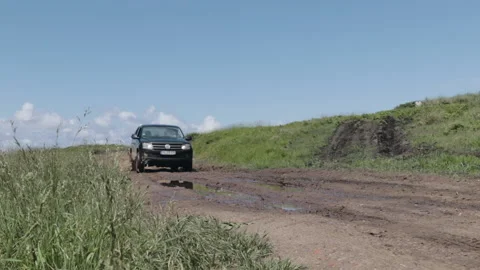 Pickup truck driving through puddle splashing mud Stock Footage 138762816