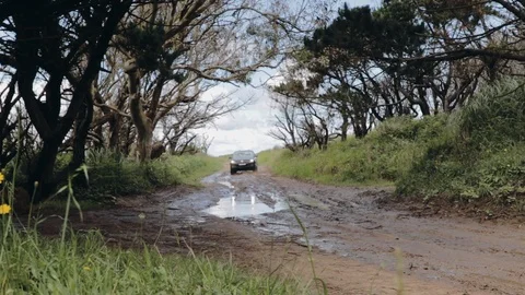 Pickup truck gets dirty while driving through mud in slow motion Stock Footage 97411745