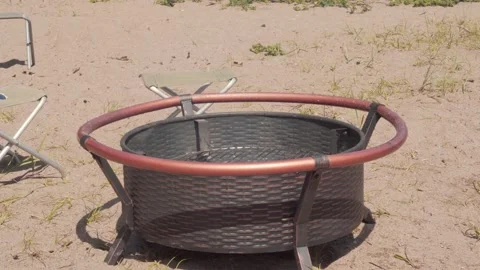 Picnic area with fire pit and folding stools. Moving camera. Video stock 157288371