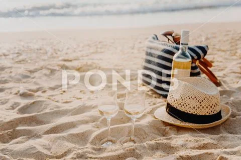 Picnic background with bag, grape and white wine by blue sea Stock Photos