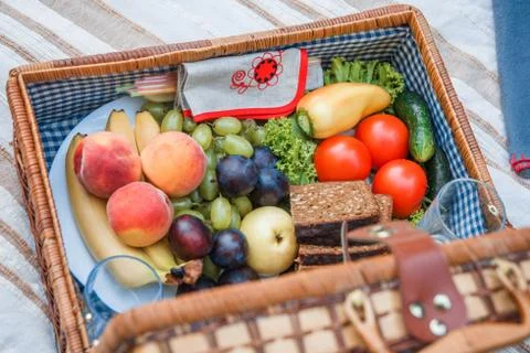 Picnic basket with fruit and bread close up Stock Photos