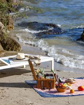 Picnic basket by the sea. Stock Photos