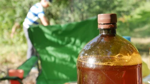 Picnic - a Plastic Bottle With a Beer on the Table and Prepare the Barbecue in Stock Footage 64924063