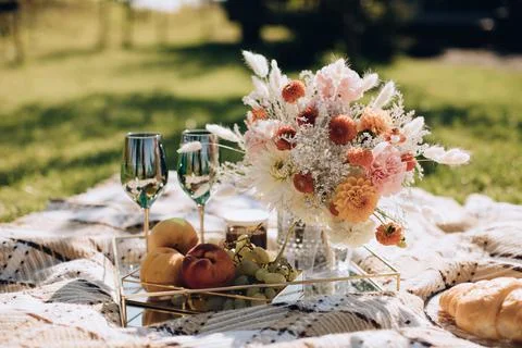 Picnic setting for two. Wedding Dinner served for two outdoor on green grass 写真素材