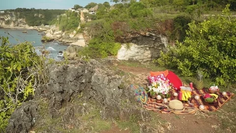 Picnic setup on Bali cliff shore Stock Footage 77954397