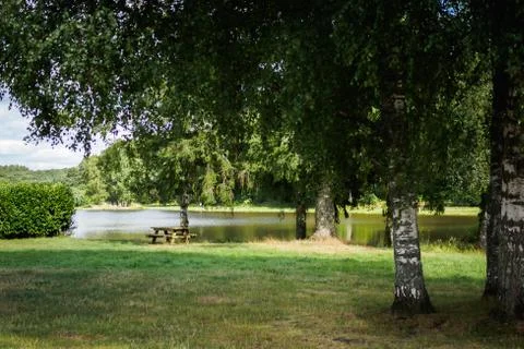 Picnic table on the lake Stock Photos