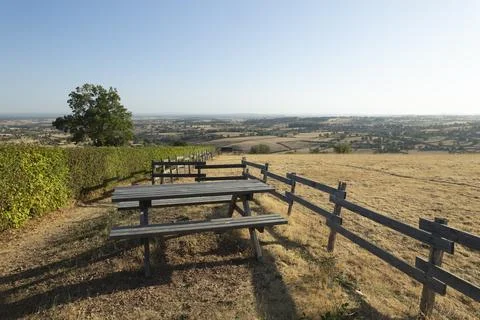 Picnic table overlooking dry fields and vineyard in Saint Julien de Jonzy Fotos de archivo